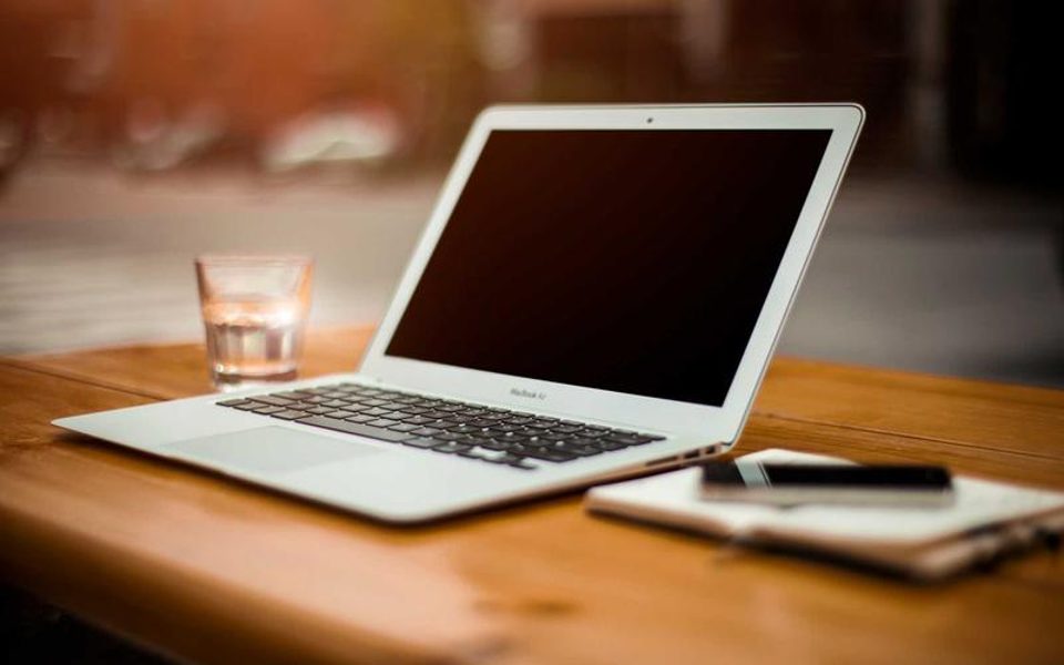 A tidy desk with an open laptop